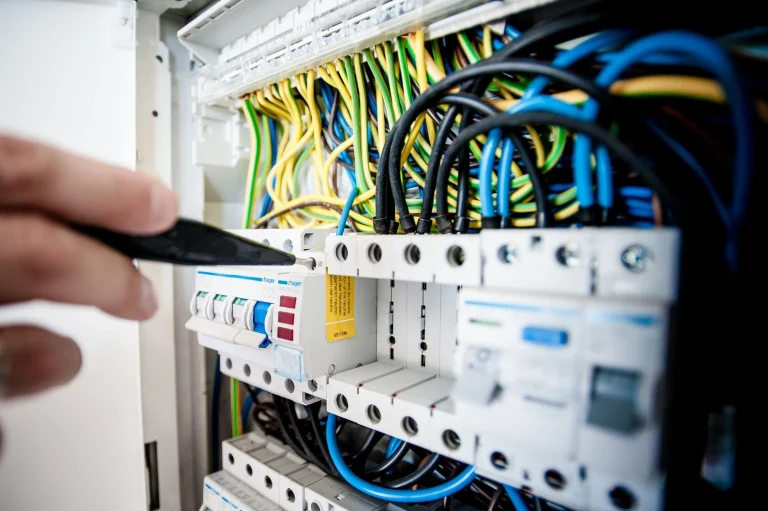 Electrician working on an open switchboard